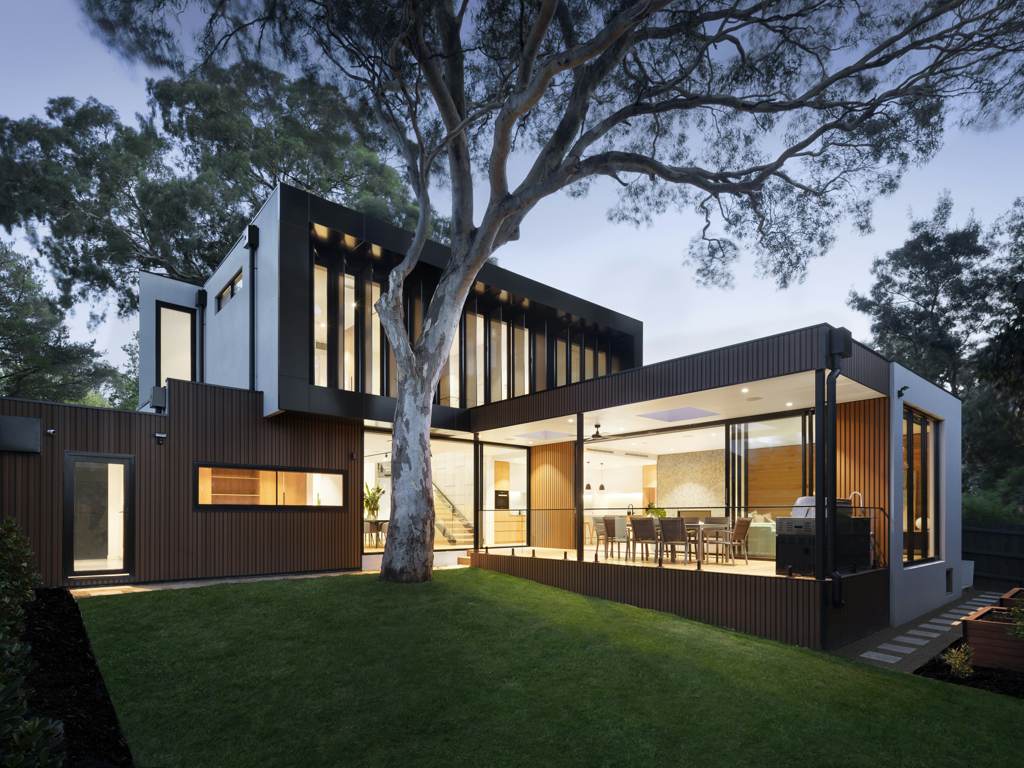 Modernist white villa with floor-to-ceiling glazing at dusk